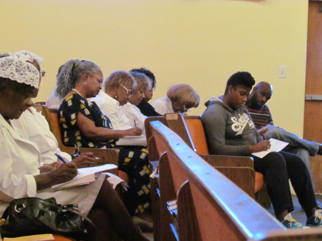 Diverse congregation smiling and worshiping in a modern church interior