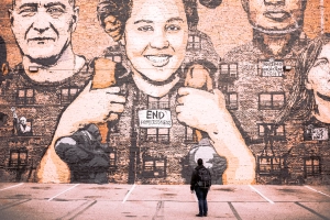 Man looking at a graffiti on wall