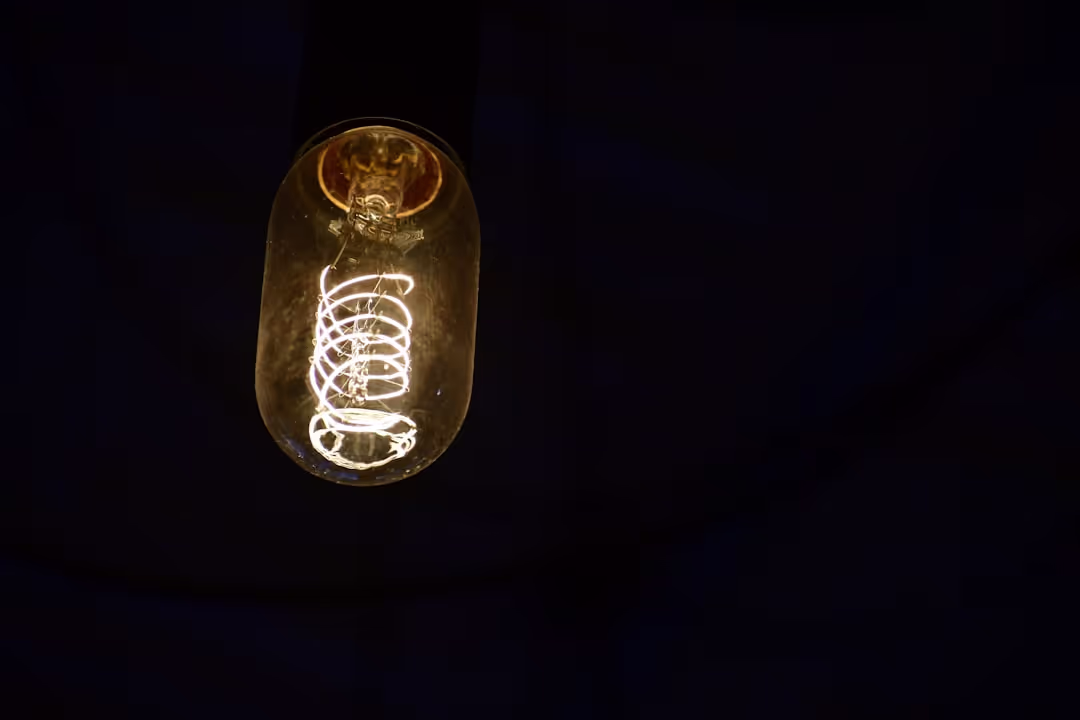 Lightbulb amidst interconnected gears