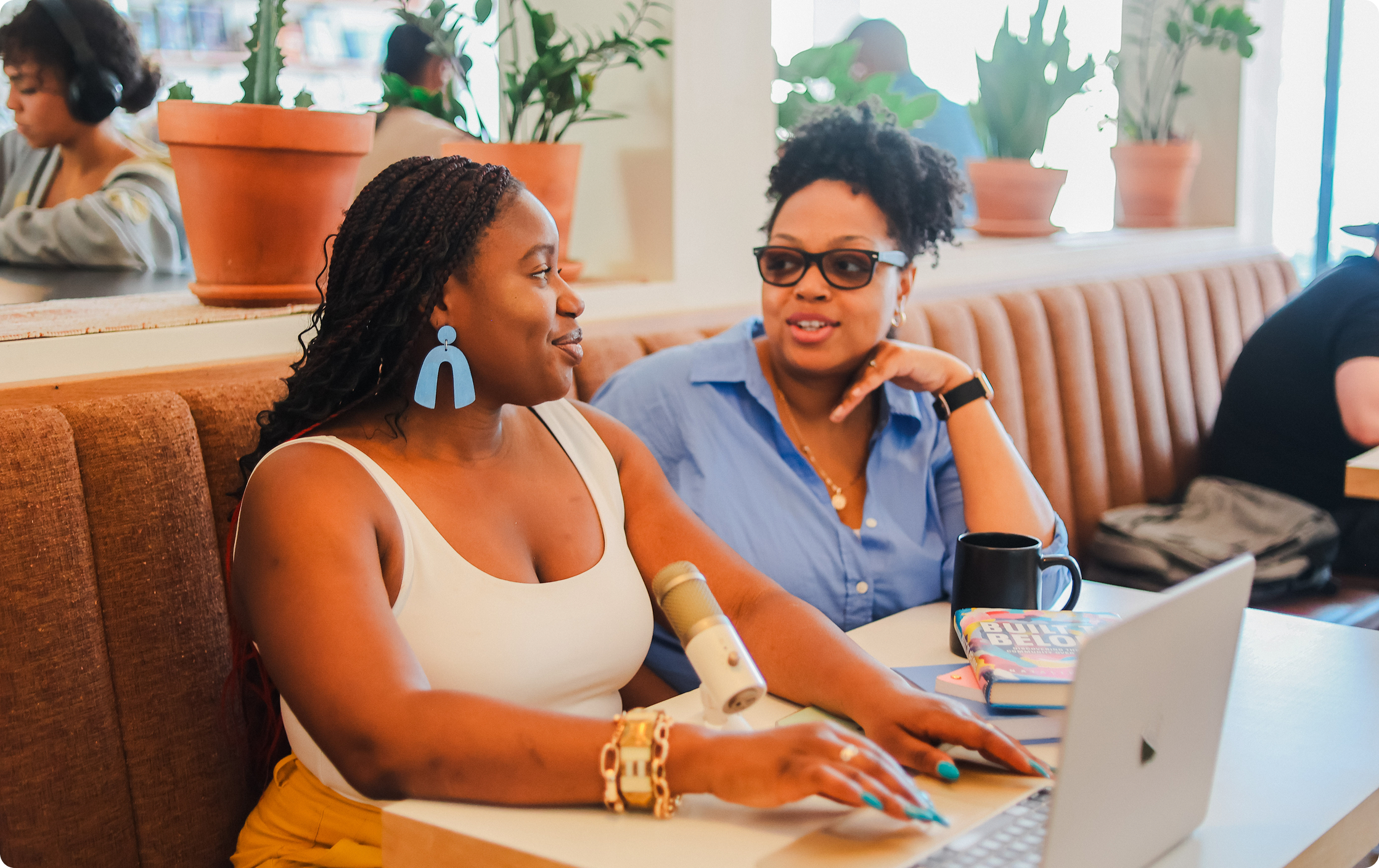 Happy colleagues collaborating at a coffee shop