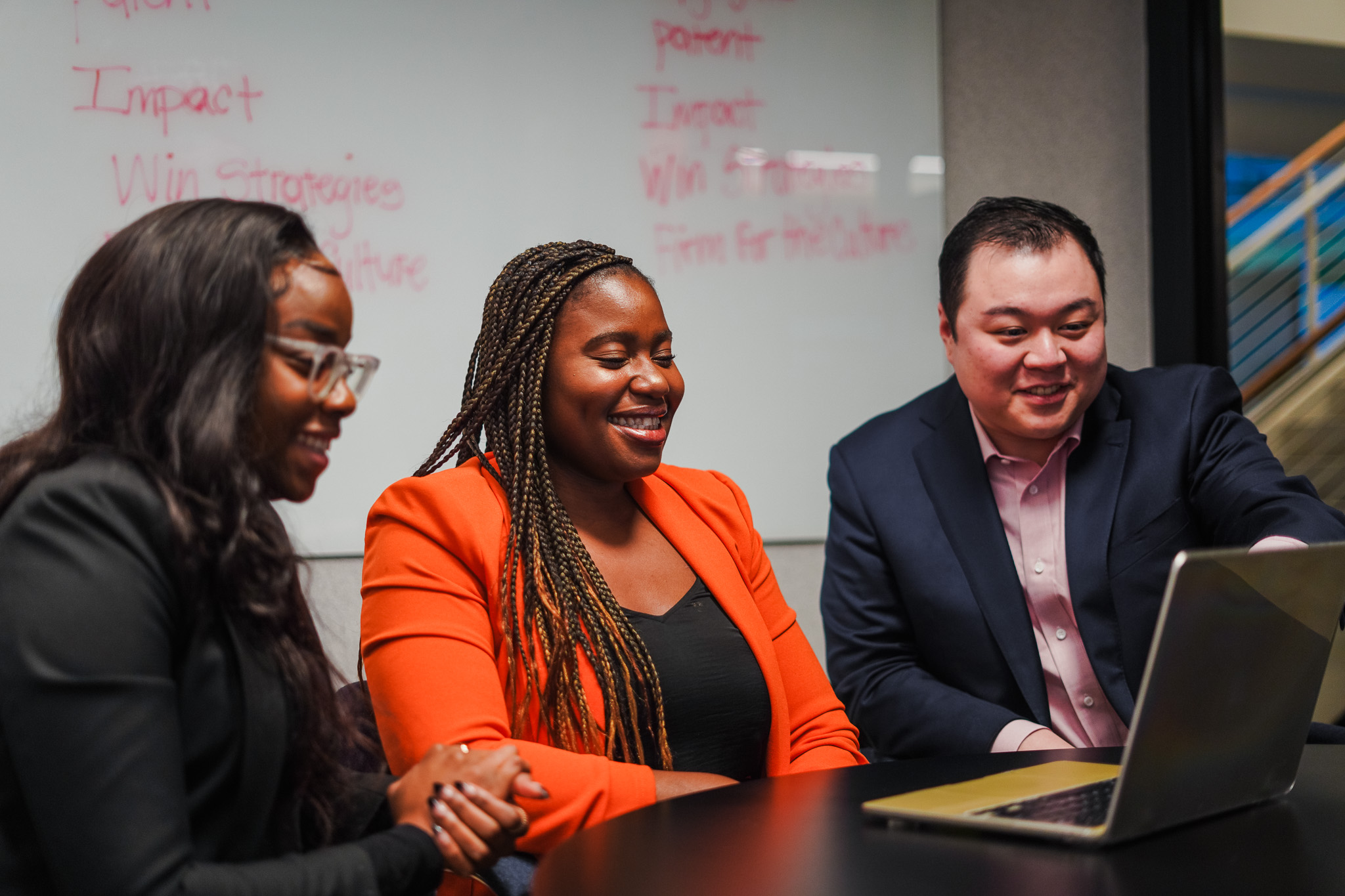 Two professionals discussing work with a laptop