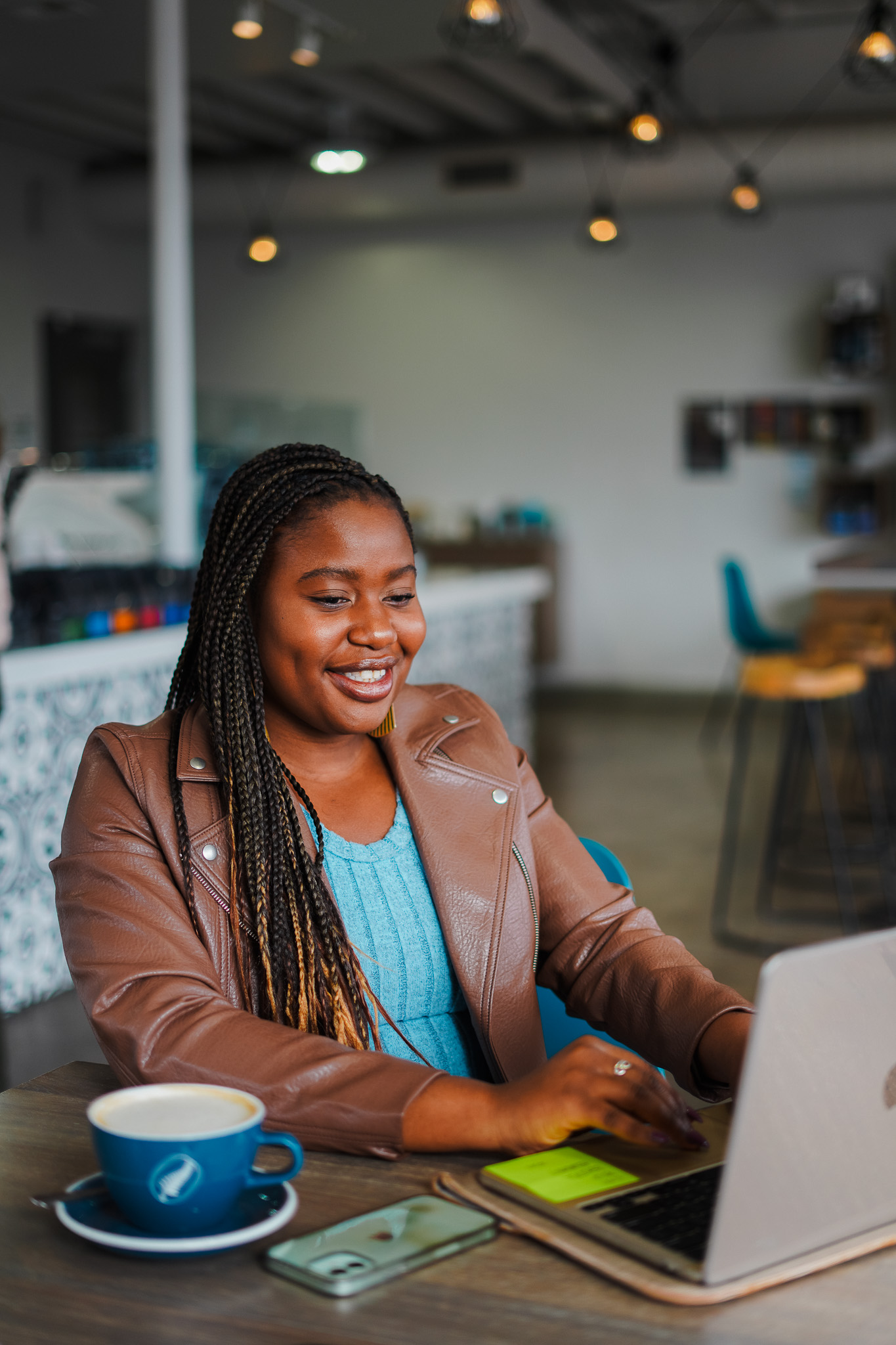 Two professional women discussing in a cafe