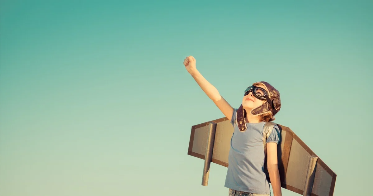 A child imagining flying through the sky.