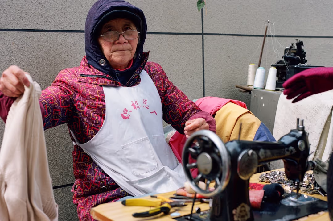 Debbie happily crafting in her workshop with a cheeky grin