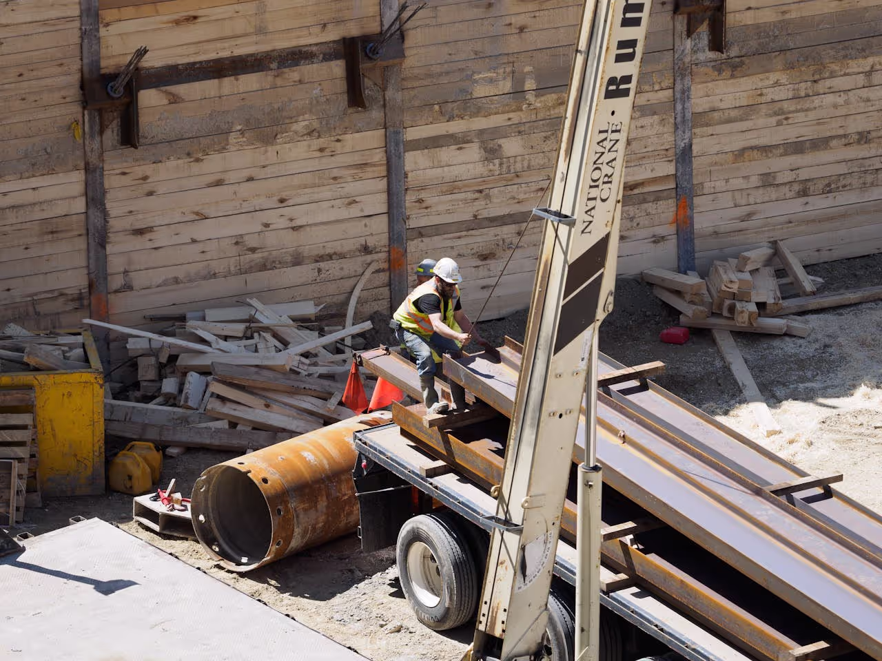 Worker lifting and organizing warehouse steel in a truck for warehouse steel recycling Sacramento in a clean, OSHA-safe environment.