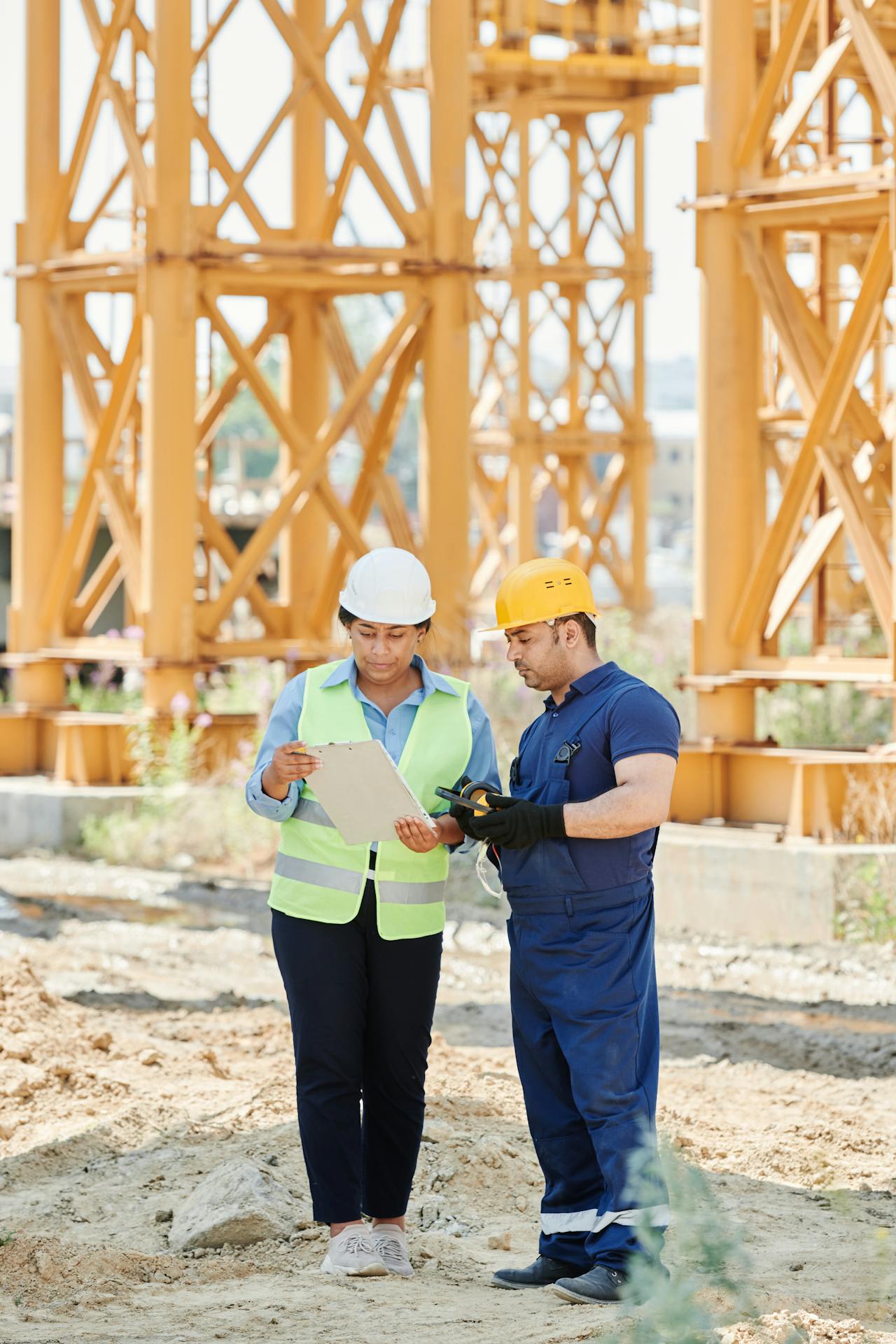 Workers on a construction site reviewing a checklist of requirements for warehouse steel recycling Sacramento.