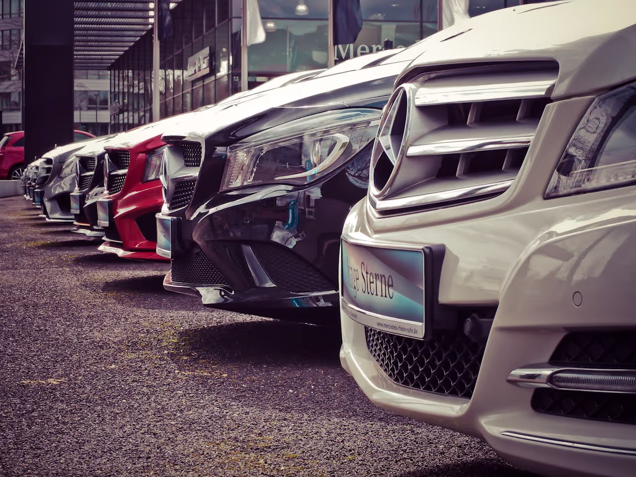 Luxury-cars-lined-up-at-an-outdoor-dealership-showcasing-sleek-designs