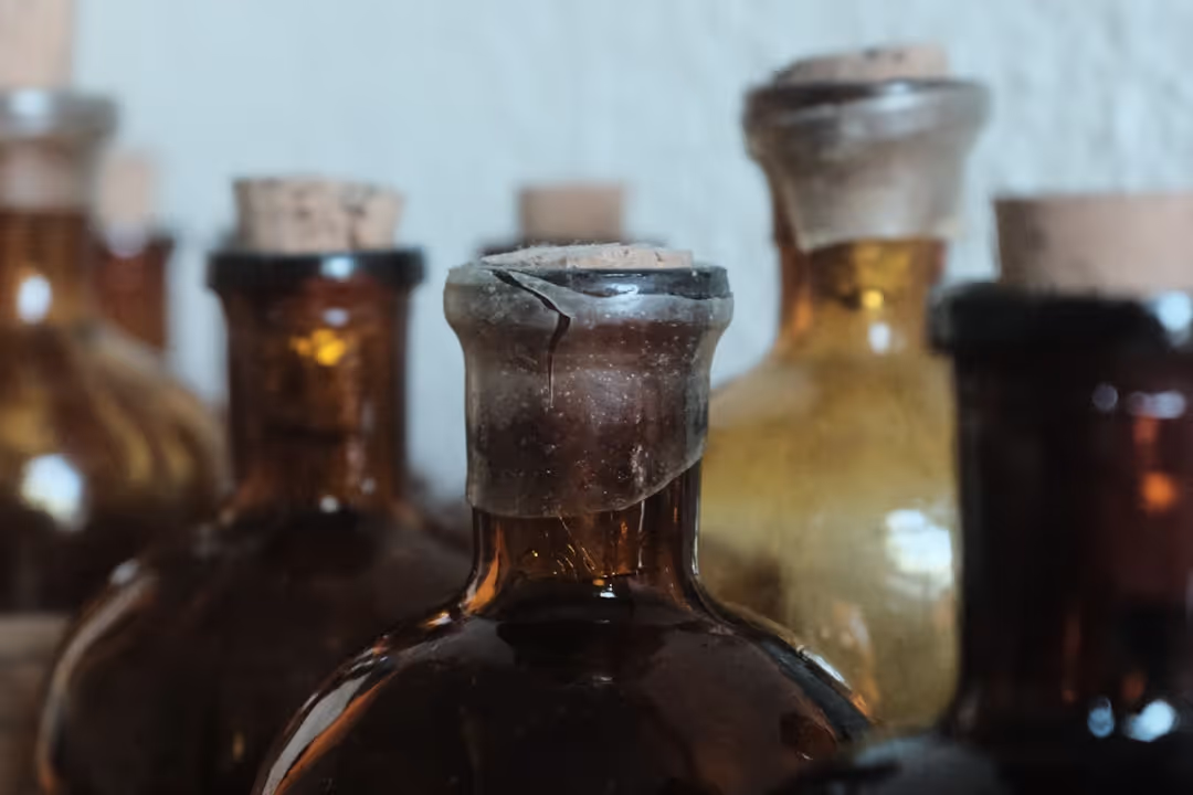 A selection of custom essential oil blends in amber bottles.