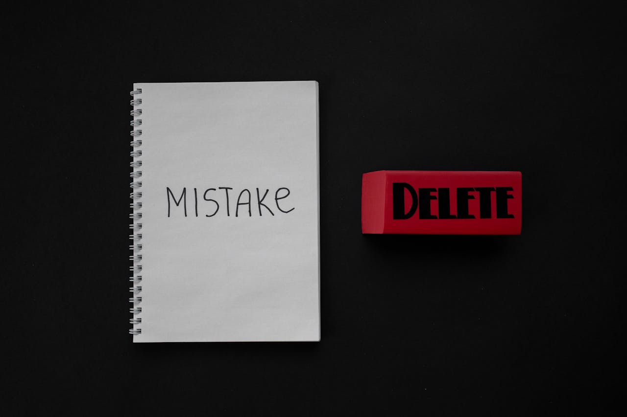 image shows a notepad with the work mistake on it and an eraser with the word Delete