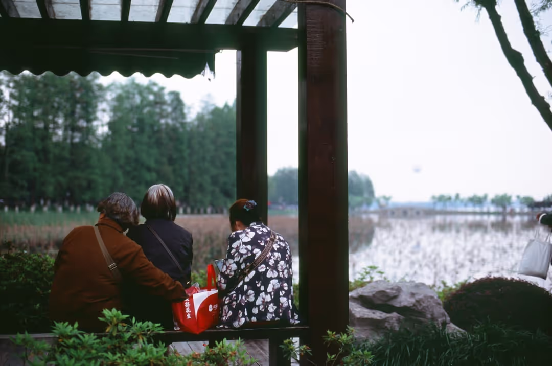 A family peacefully enjoying a cup of tea on the verandah, soaking in the serene natural surroundings of Doon Niwas.