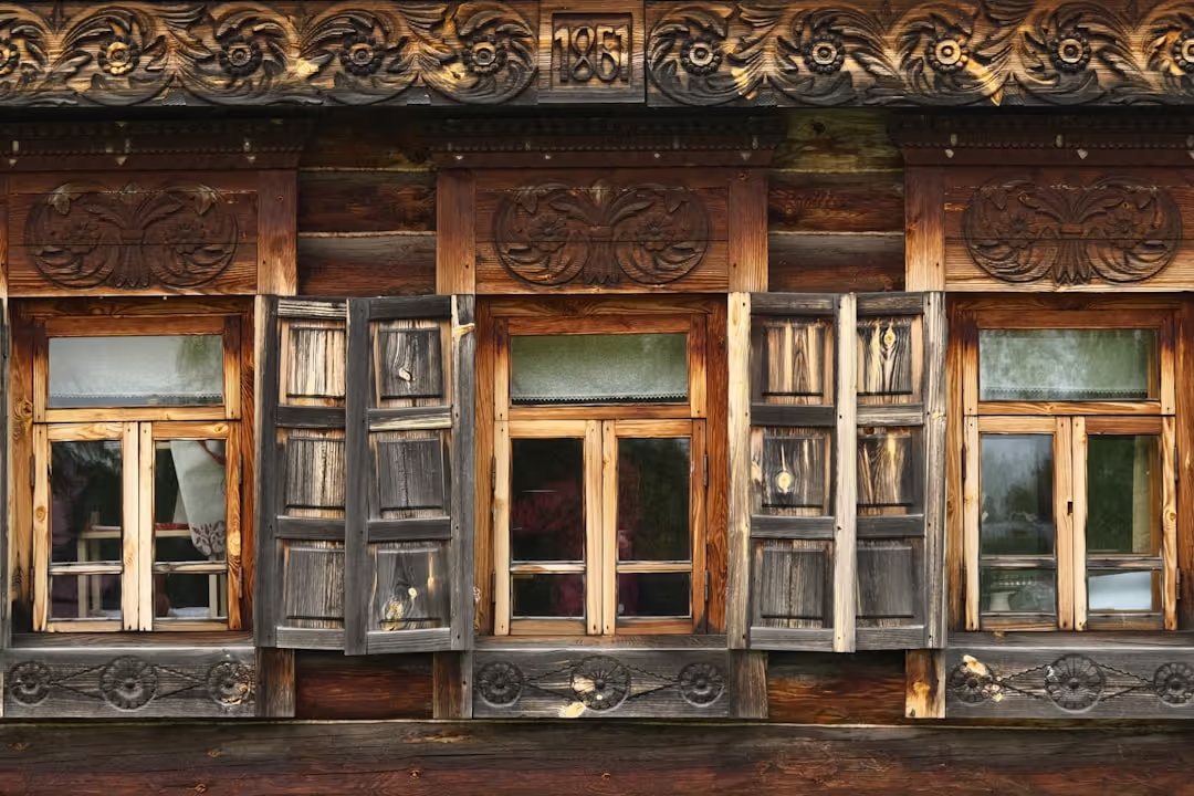 A charming and cozy traditional Indian homestay building, possibly from the early days of Doon Niwas, nestled in a green landscape.