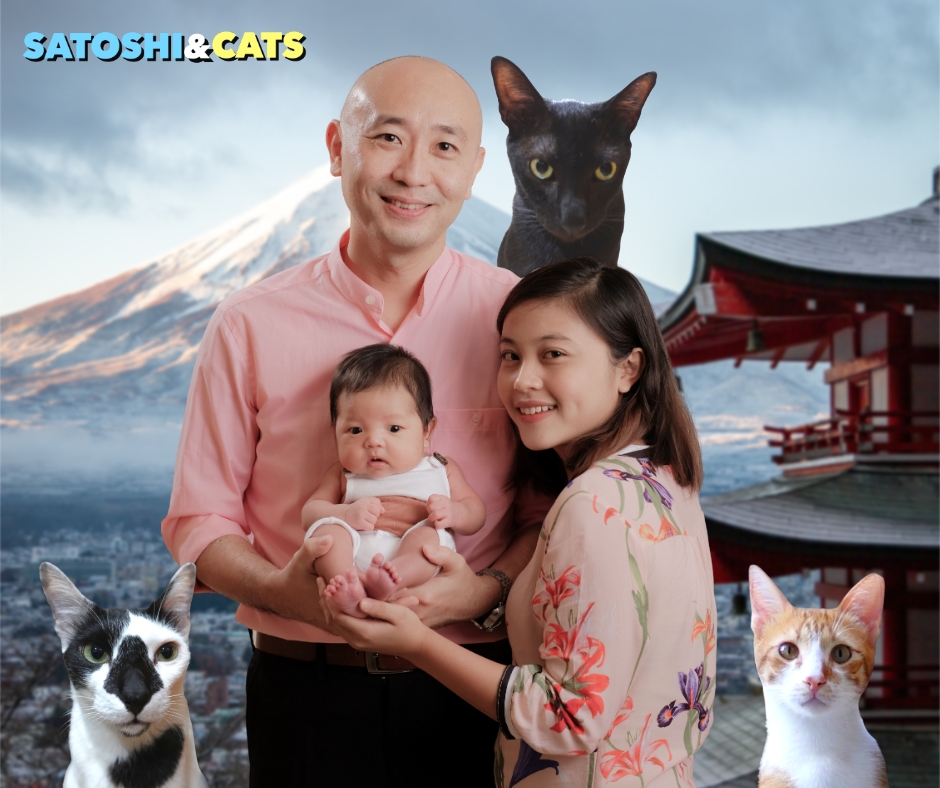 Satoshi smiling with his three cats, Buchie, Panther, and Piper, representing cross-cultural understanding.