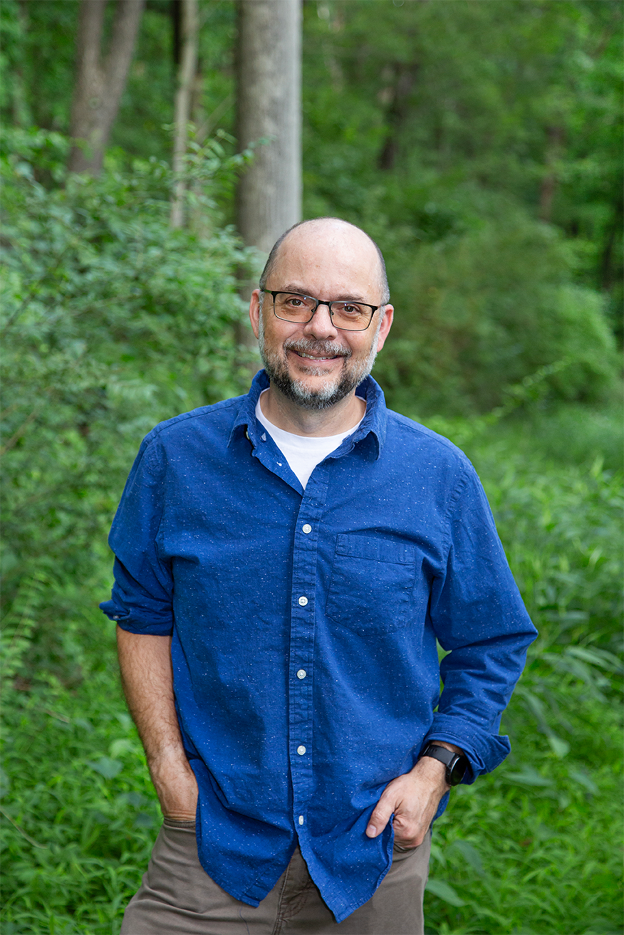 Man folding arms and smiling