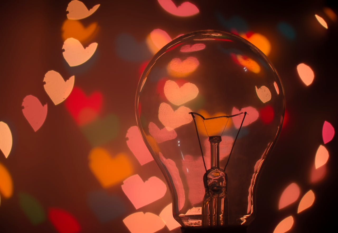Light-bulb-with-colorful-heart-shaped-bokeh-creating-a-warm-and-romantic-mood