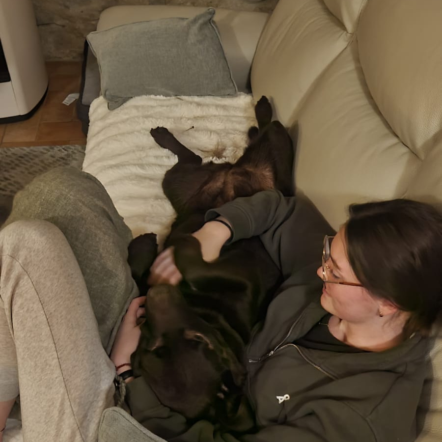 Caro with a Labrador on the couch