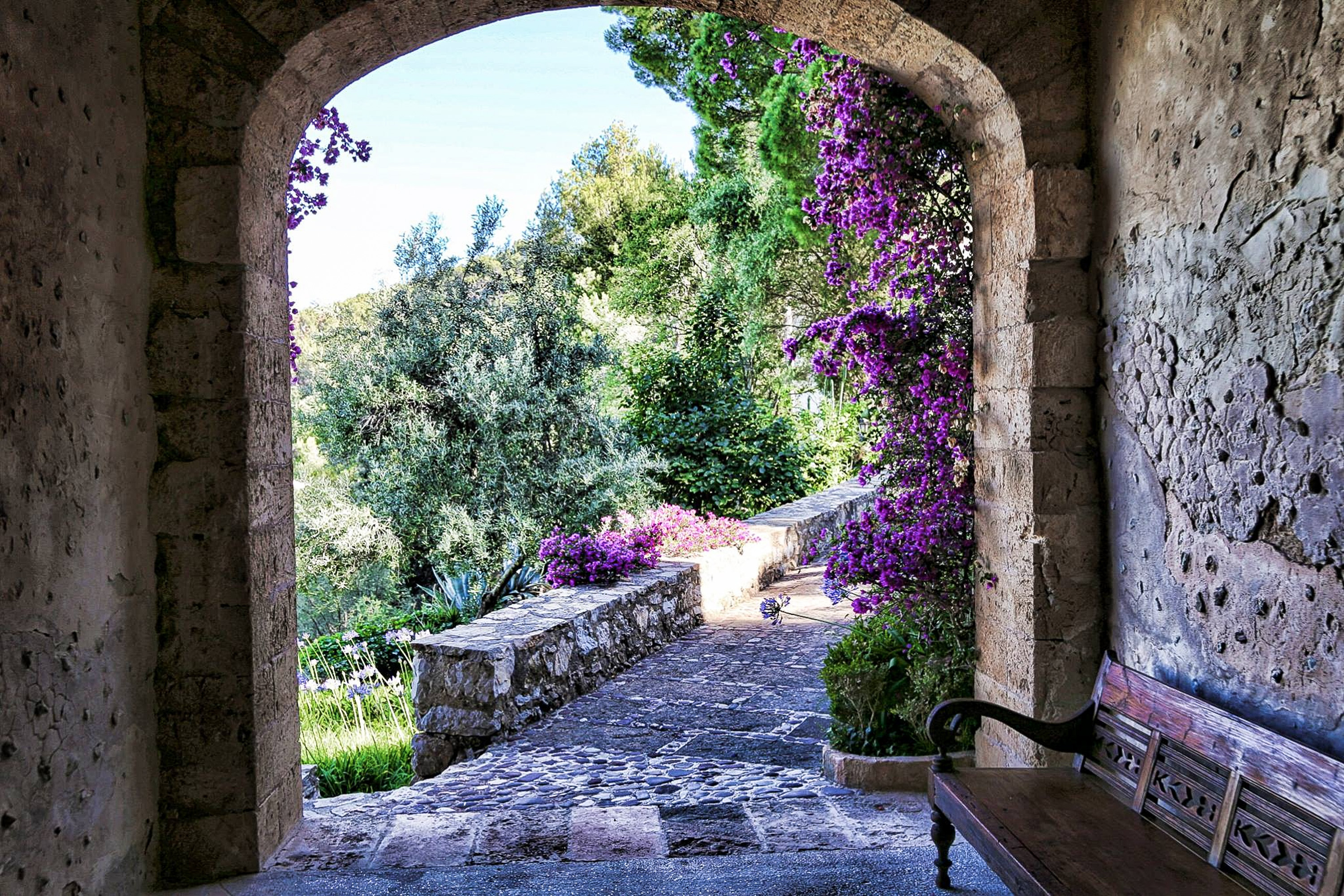 Historic stone facade of Posada del Marqués bathed in golden light