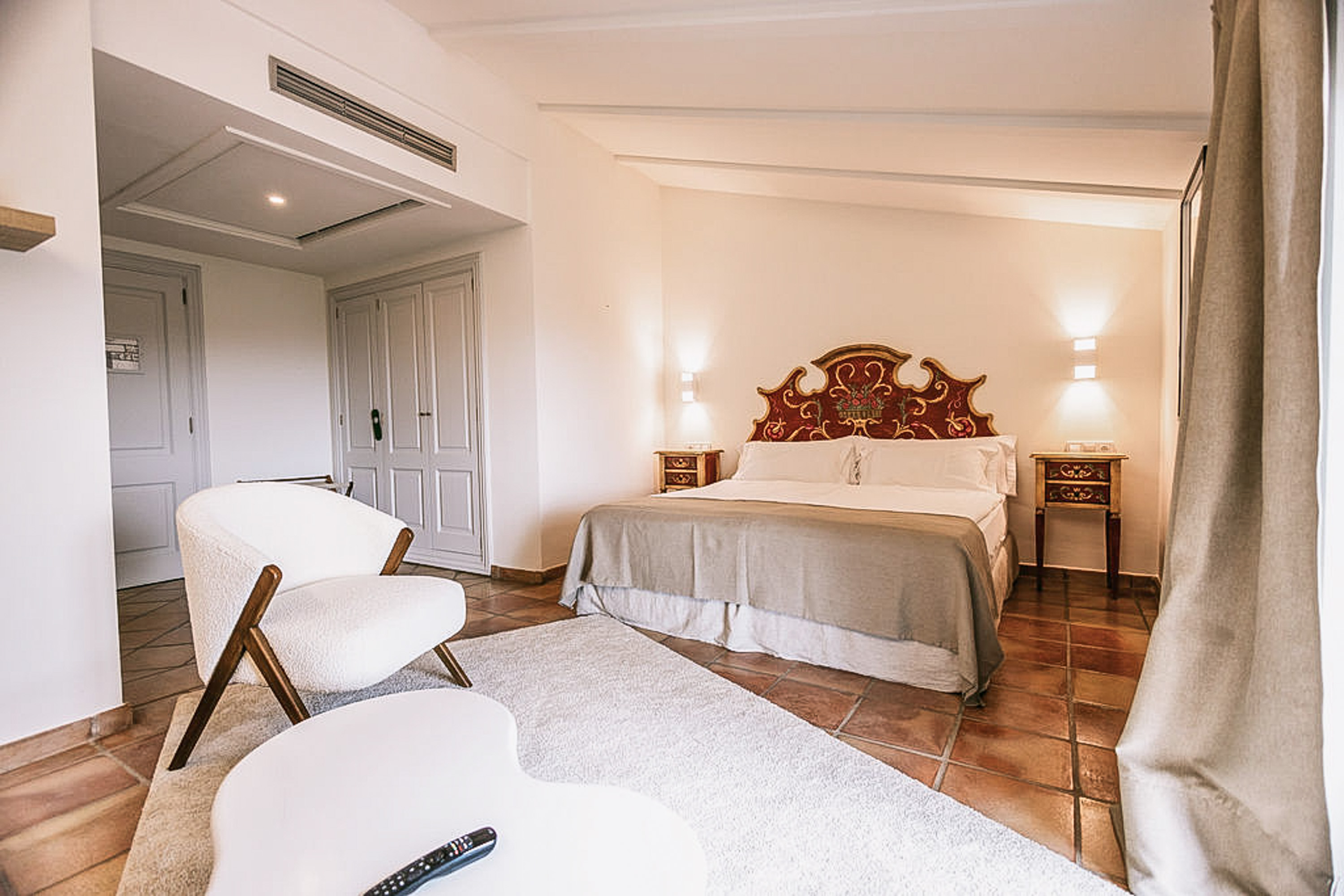 Luxurious king-size bed with pristine white linens and decorative pillows