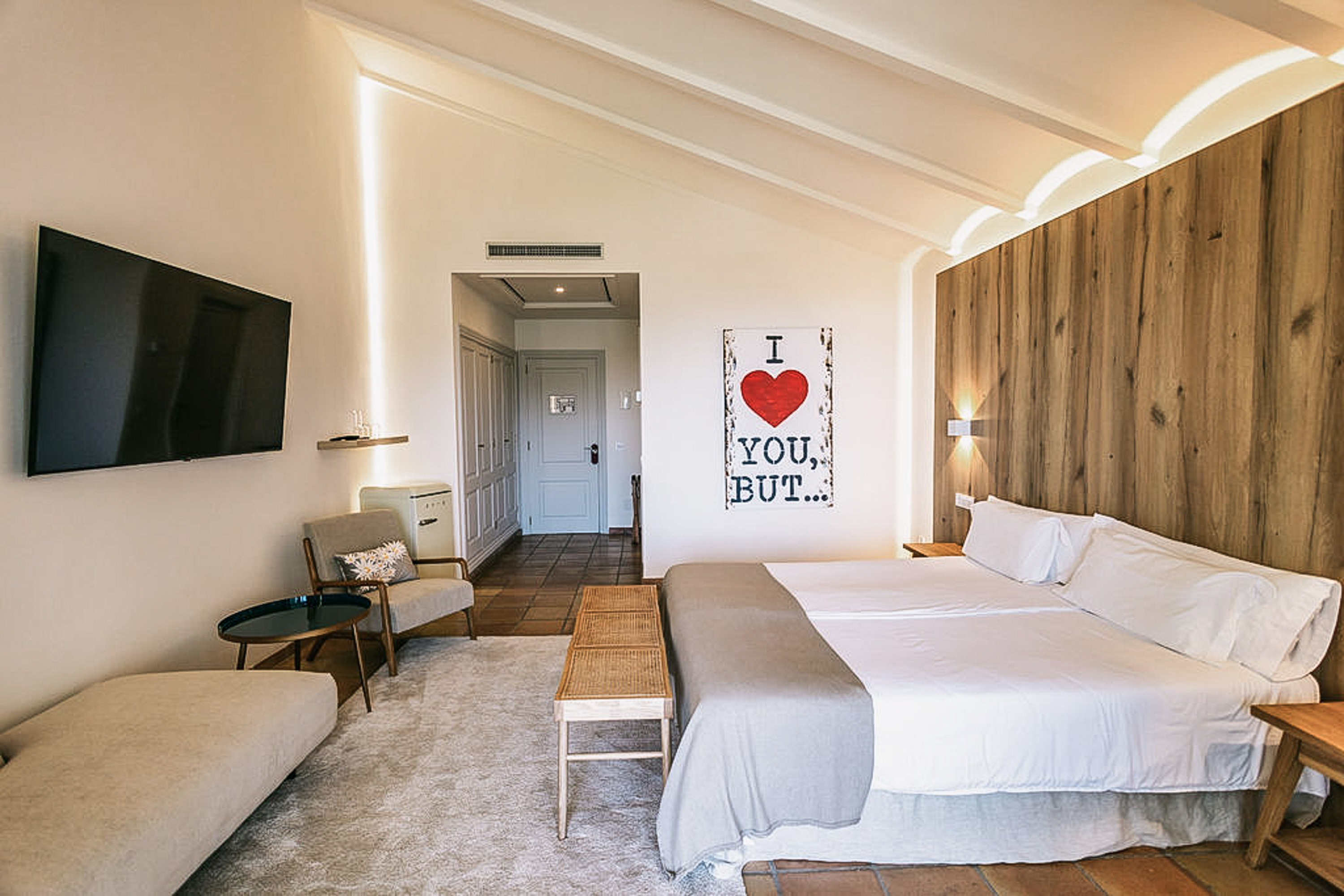 Luxurious king-size bed with pristine white linens and decorative pillows