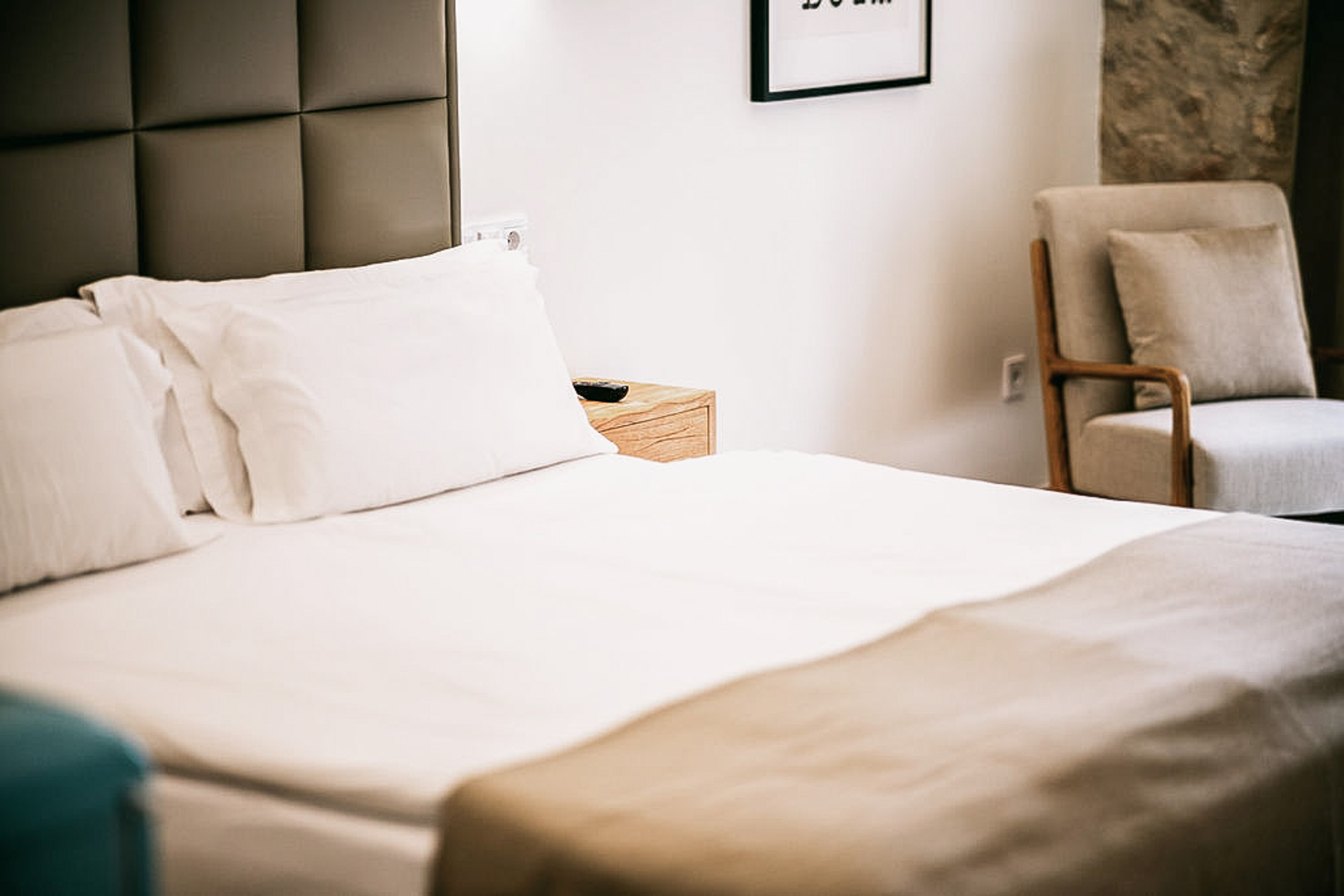 A close-up view of the king-size bed in the Junior Suite, highlighting the luxurious bedding and elegant headboard.