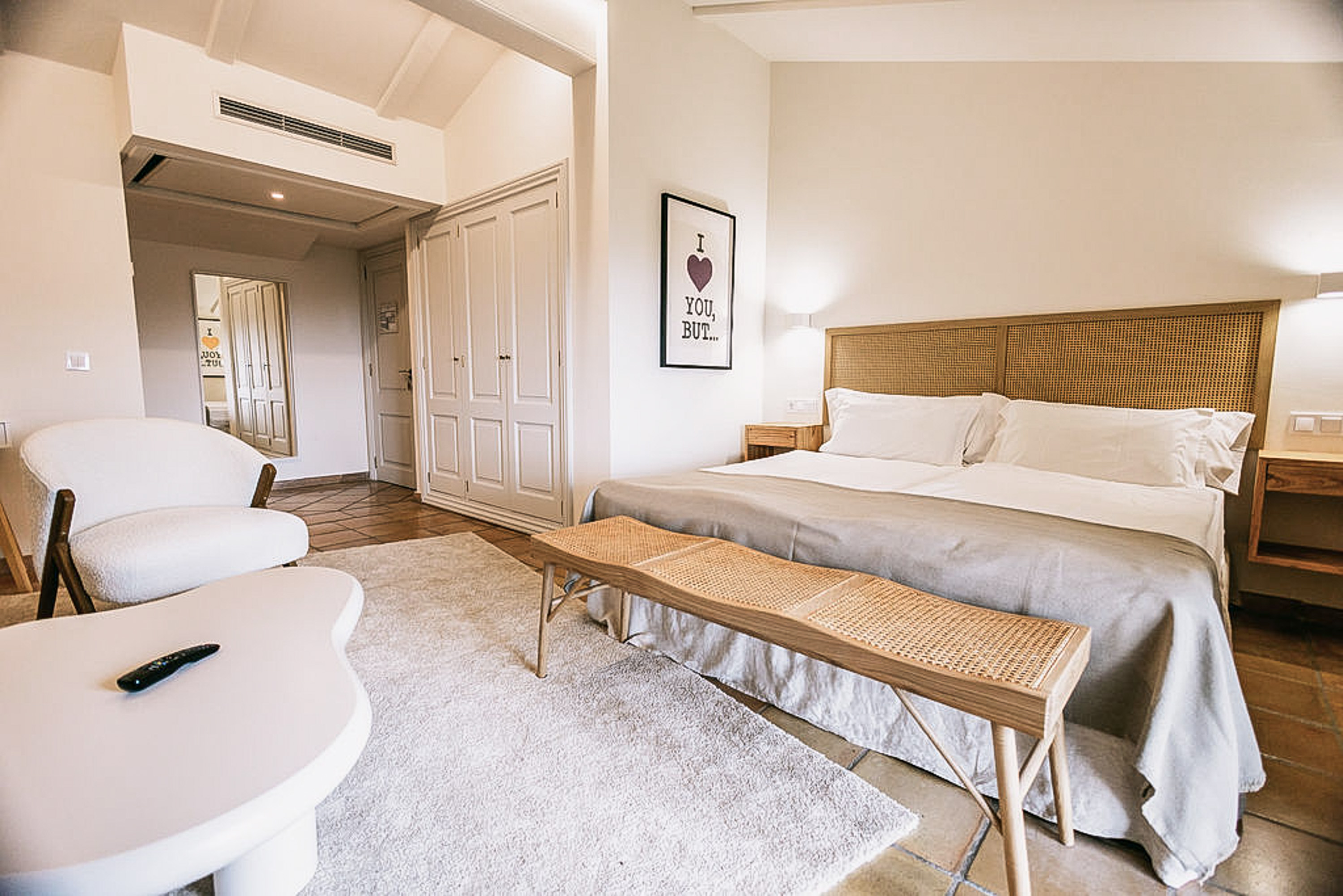 Elegant Deluxe Double Room with a large king-size bed and modern decor