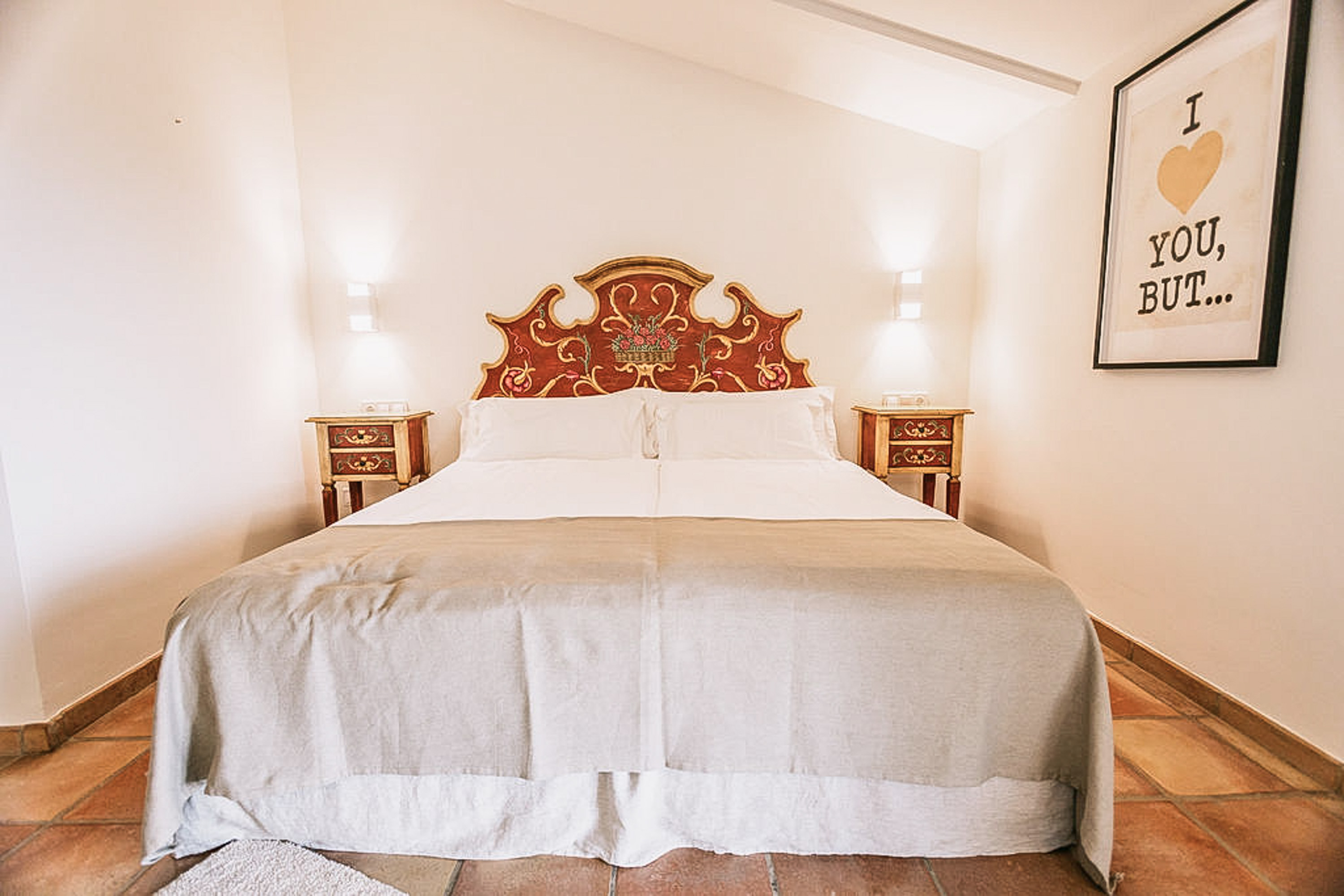 Luxurious king-size bed with pristine white linens and decorative pillows