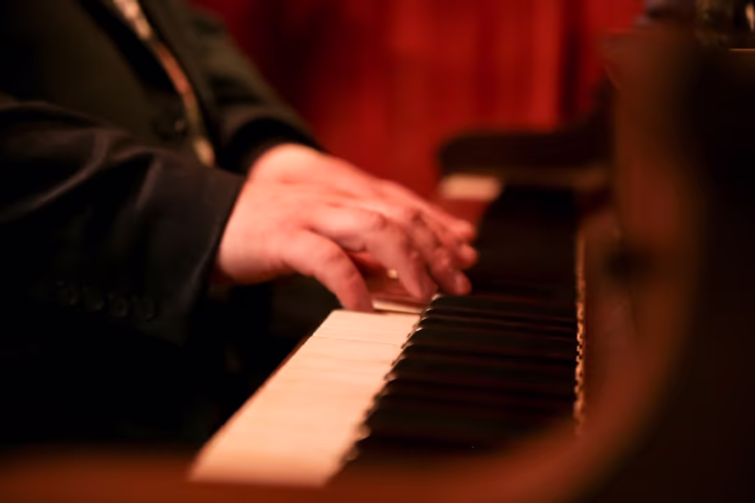 Photo of a male student at a piano