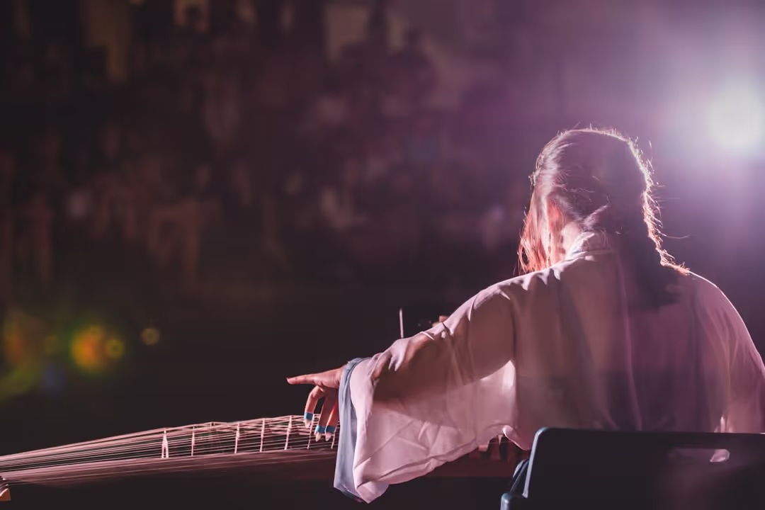 Student performing with guitar and singing