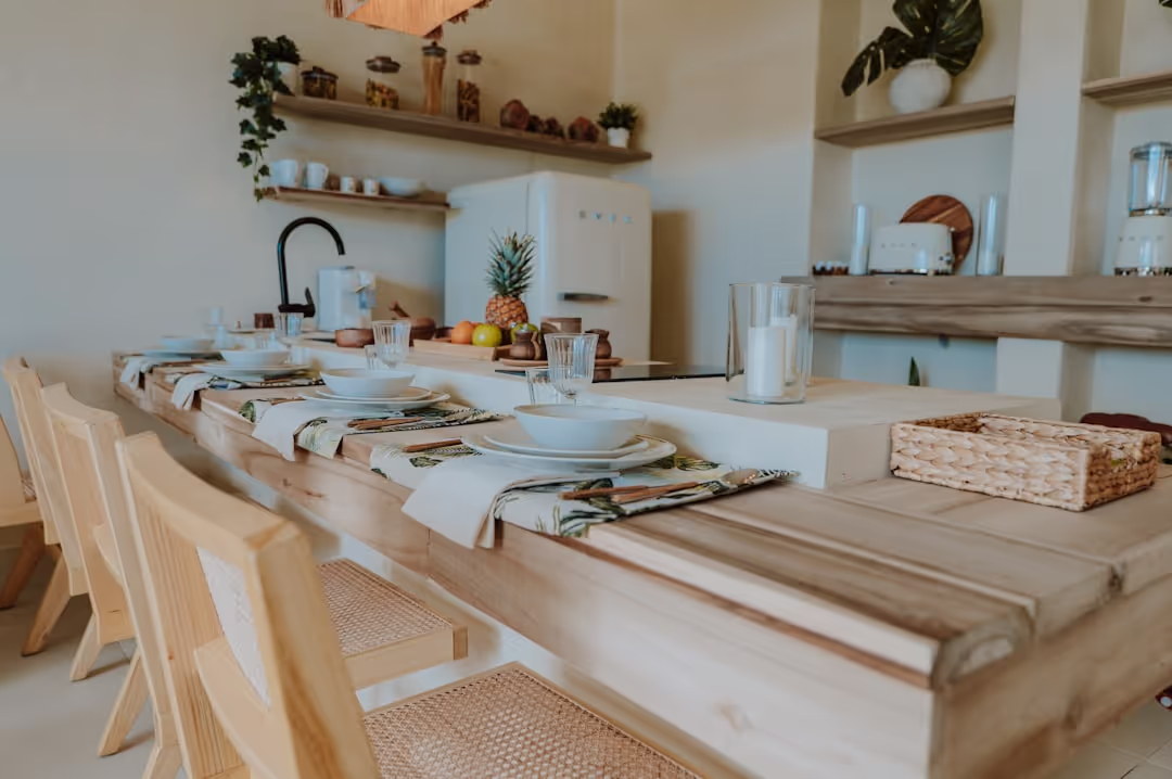 A high-end espresso machine on wooden countertops in a modern rustic kitchen, filled with natural light.