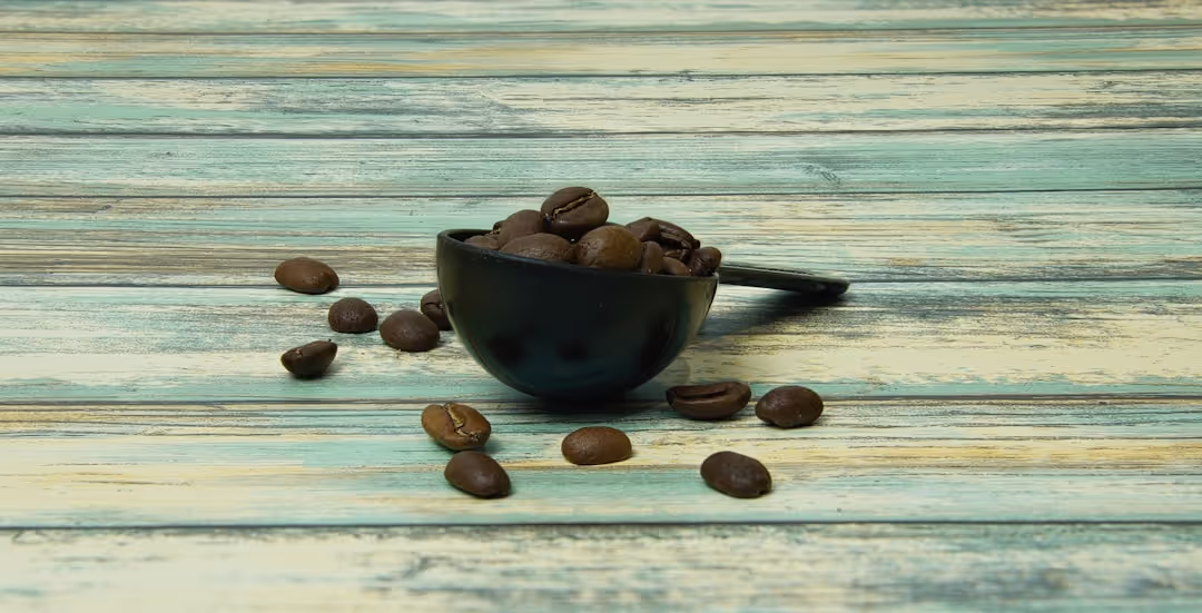 Premium coffee beans in a rustic wooden bowl