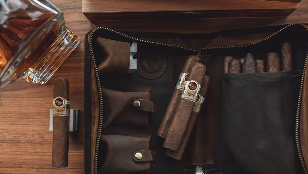A vintage leather travel bag with coffee gear, a map, and a freshly brewed cup, evoking adventure.