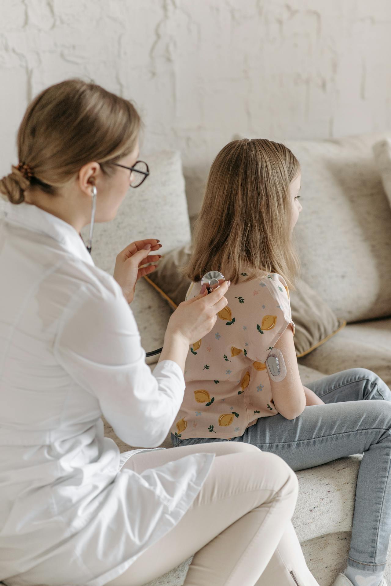 pediatric practitioner checking vitals of young female patient