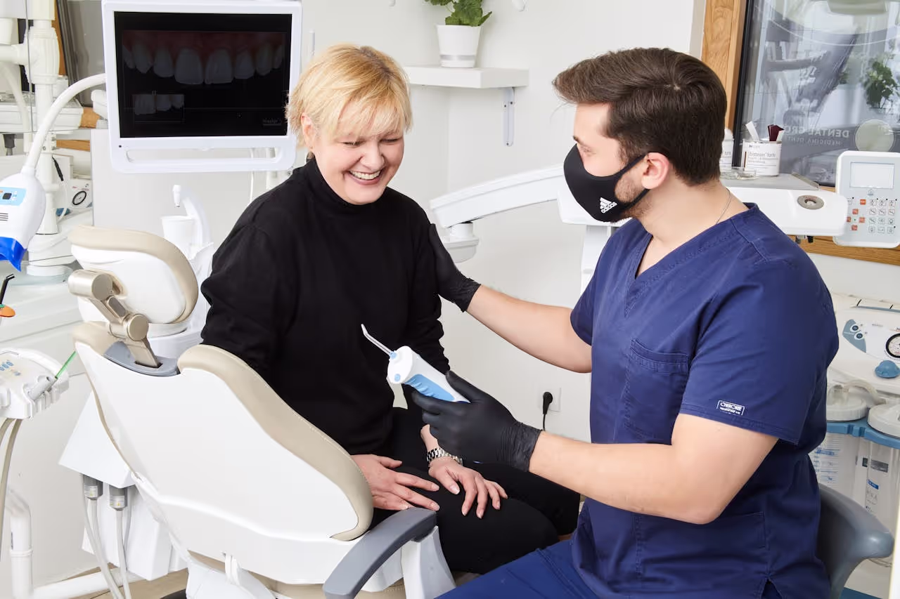 Dental professionals examining a patient using specialized tools and equipment in a clinic
