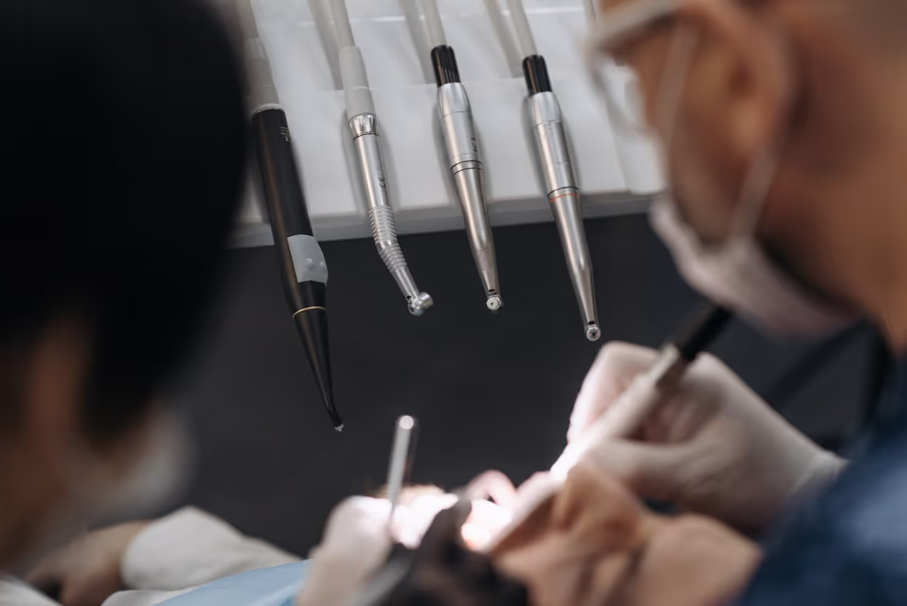 Close up of dentists working on a patient with specialized dental instruments