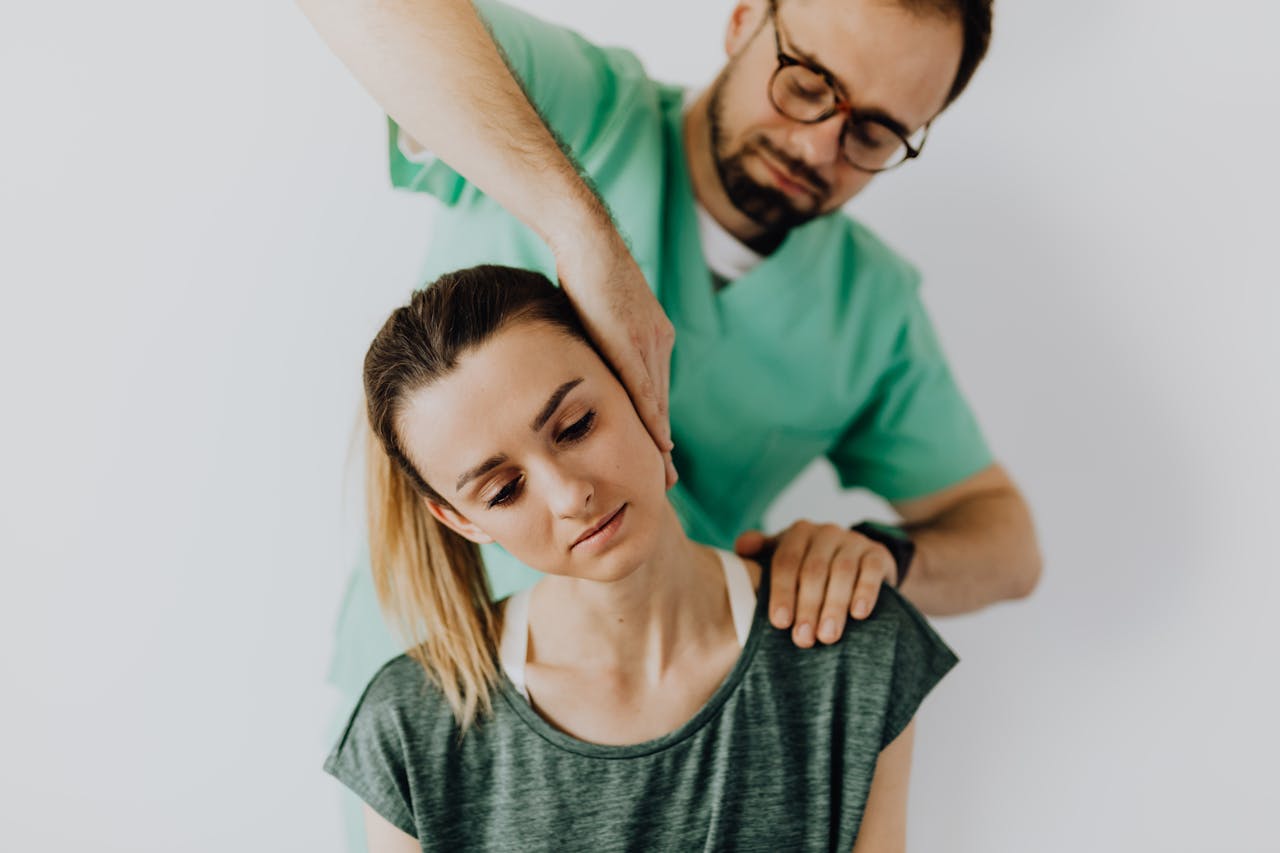Professional chiropractor treating a woman's neck pain with therapeutic techniques