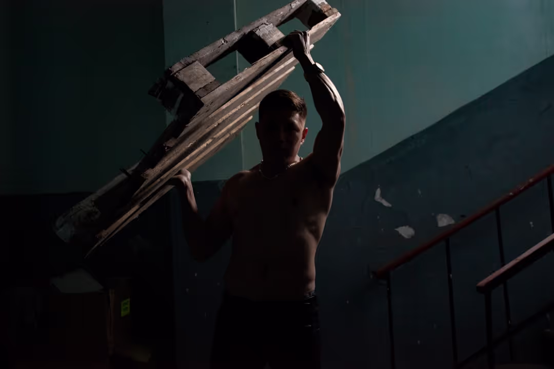 Man pushing a sled in a gym