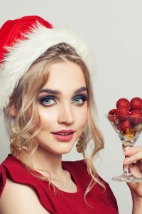 Girl posing with glass of cherries in hand